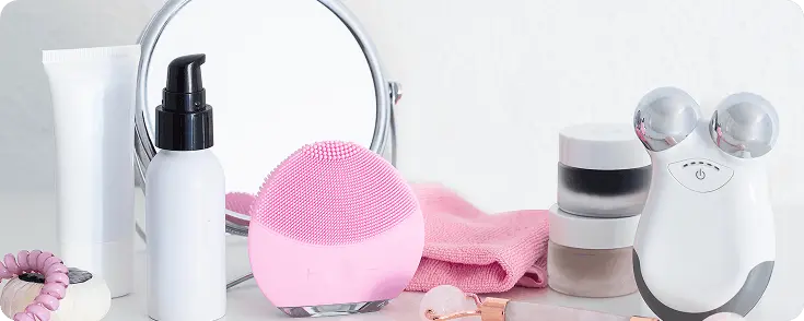 Assorted makeup products on pink background