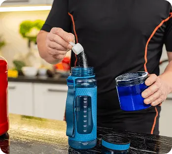 Supplement powder being added to a shaker bottle for mixing