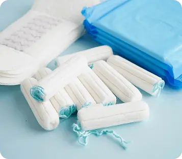 Hands holding menstrual cups and container